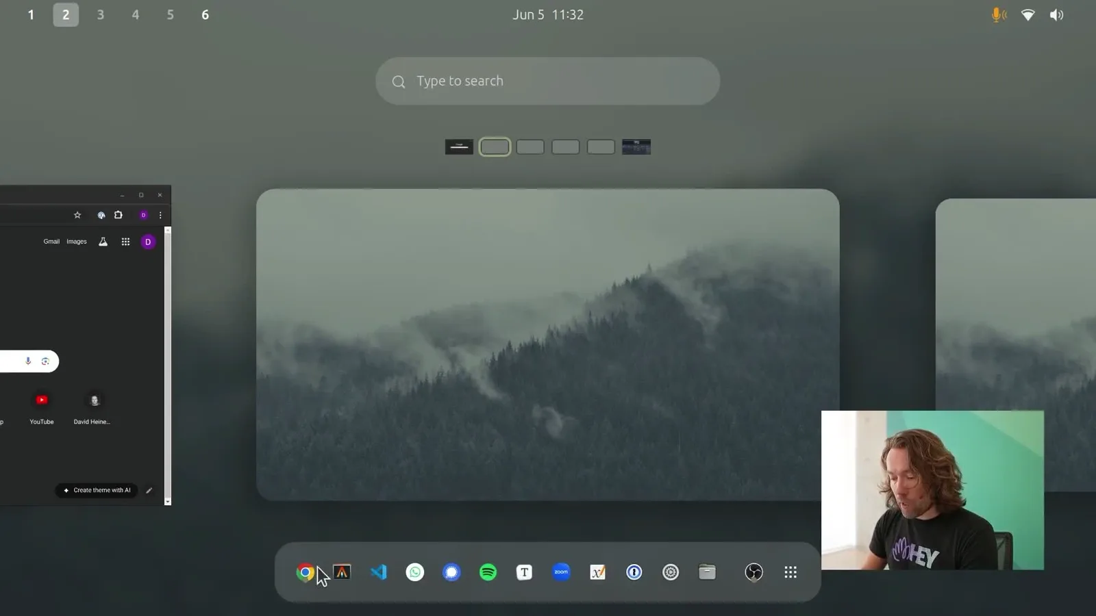 The Omakub desktop: GNOME overview with a misty forest wallpaper, dock, and workspaces